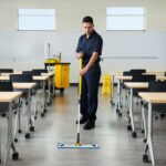 A cleaner mopping the school