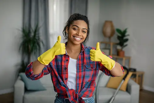 A cleaning girl with thumbs up