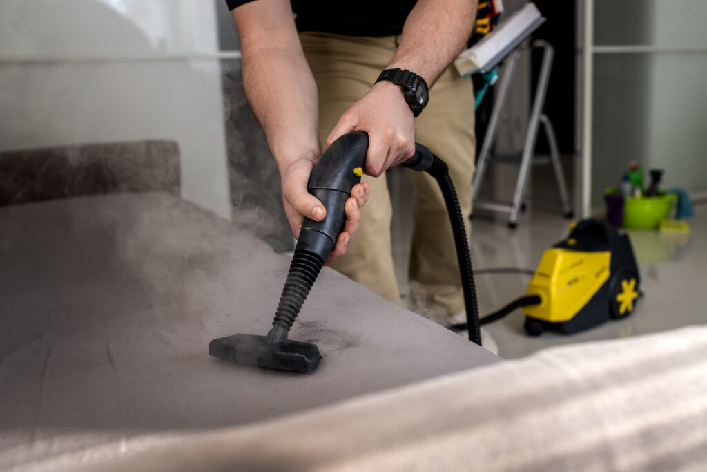 Man steam cleaning a carpet