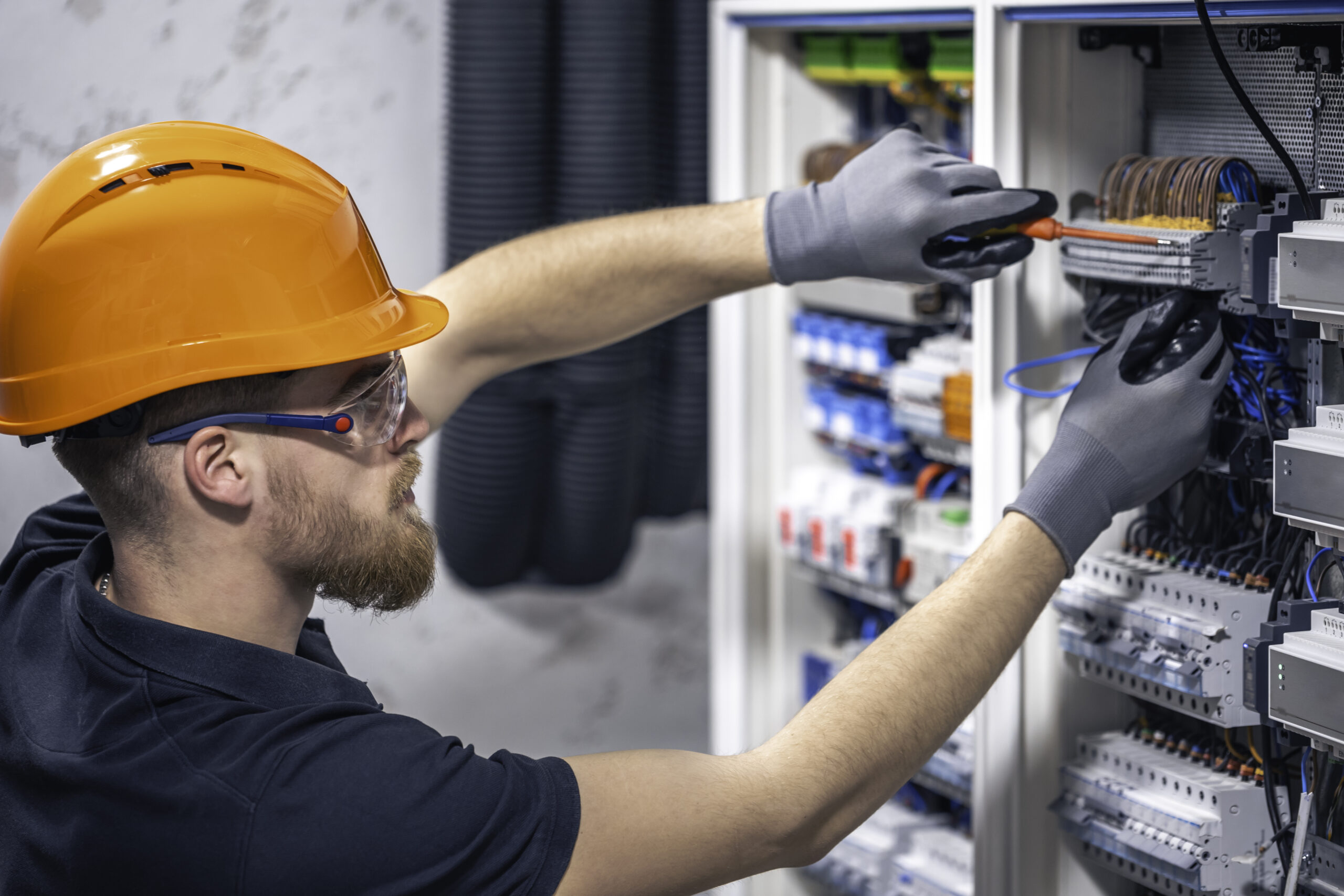 Electrician working on a control panel.